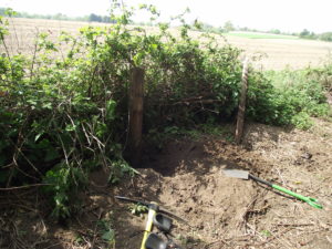 OK - it's a hole in the ground. But it does show that, as the post is buried to half its length, the ground hereabouts has risen by a couple of feet at least