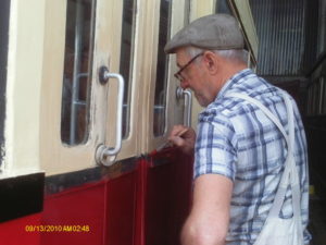 Bernie painting the Halesworth end, platform side, doors on Coach 7