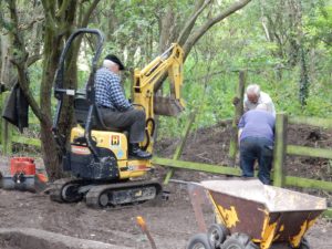 Replacing the boundary fence - James on the mini-digger - of course!