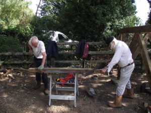 Carpenters John B and Bob both sawing an angled strut